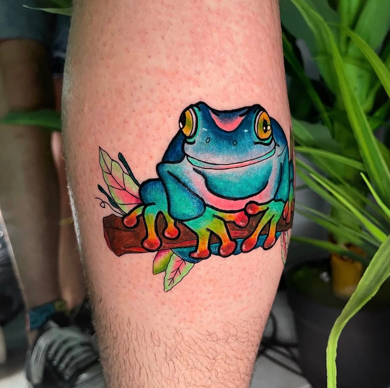 Vibrant color tree frog arm tattoo by Aris at Pangea Ink