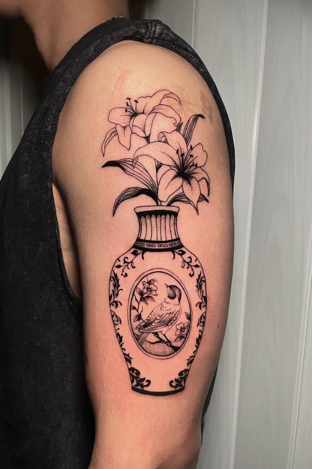 Fine line lily bouquet in a vase tattoo by Aris
