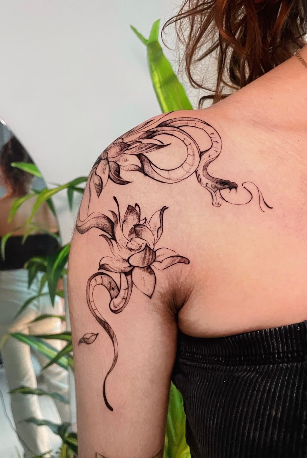 Fine line snake and flowers shoulder tattoo by Aris